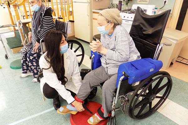 Doctor caring for senior woman in wheelchair