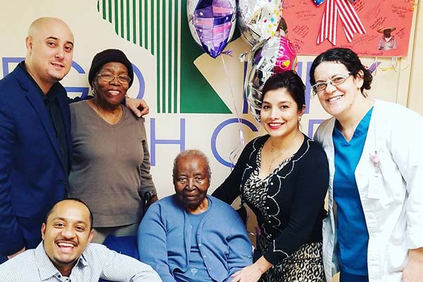 Rego Park staff and resident celebrating 107th birthday.